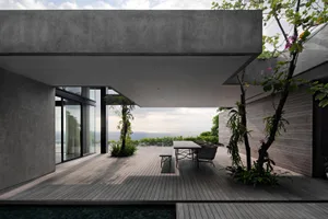 Modern outdoor patio with concrete flooring and seating area.