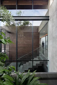 Modern staircase with glass panels and concrete steps