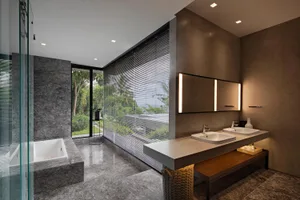Modern bathroom featuring marble and concrete materials with a large window and double sink.