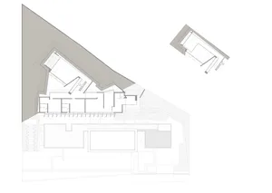 A modern building exterior featuring a concrete facade and roof.