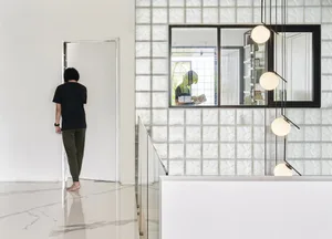 A modern living space featuring textured tile walls and floors.