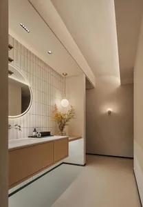 Modern minimalist bathroom featuring ceramic tiles, floating vanity, and spherical pendant light.