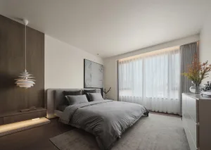 A minimalist bedroom with a gray fabric bed, white curtains, and a modern hanging light fixture.