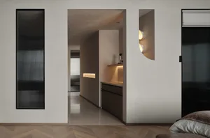 A modern minimalist residential interior featuring concrete, metal, and wooden elements.