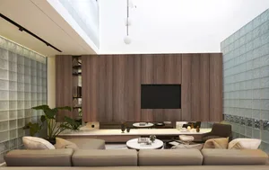 Modern living room with a focus on wood, glass, and concrete materials.