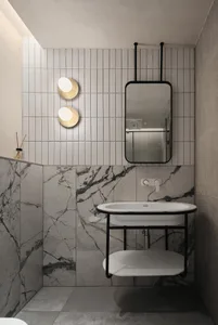 A modern bathroom with marble tiles and a floating vanity.