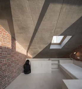 Modern minimalist living room featuring exposed brick walls and concrete ceiling.