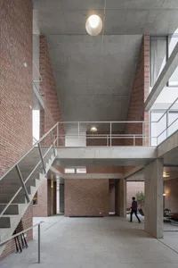 A modern interior space featuring brick and concrete walls.