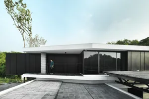 Modern house exterior with glass panels and concrete structure.