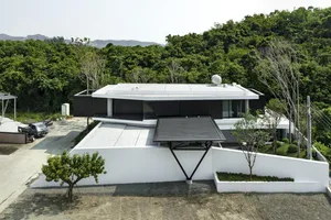 A modern residential building with concrete and glass materials.