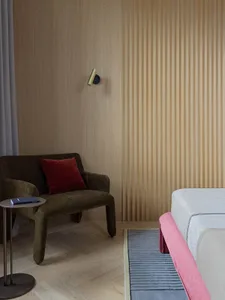 A modern bedroom featuring a sofa and couch on a marble floor.