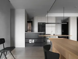 Modern residential kitchen featuring textured wood and sleek black finishes