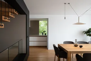 Modern living room featuring wooden furniture and glass elements.