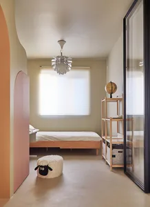 A minimalist bedroom with wooden furniture, a comfortable bed, and a cozy atmosphere.