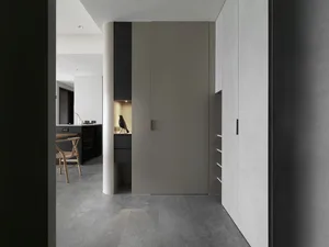 Modern minimalist kitchen with concrete flooring and minimalist design elements.