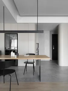 Modern, minimalist kitchen with metal accents, concrete surfaces, and timber elements.