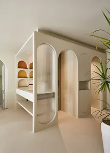 A modern office space with neutral tones and an open layout, featuring interior design elements such as clean lines and arche