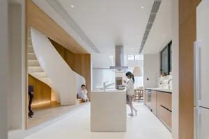 A modern interior space featuring white marble floors and a matching countertop.