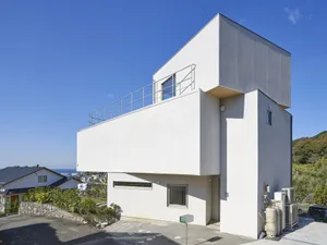 Modern, minimalist residence with concrete and glass exterior.
