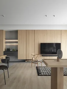 A modern residential dining room featuring wooden furniture and a minimalist design.