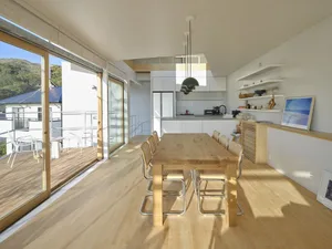 Modern residential kitchen featuring white wood materials and a minimalist design.