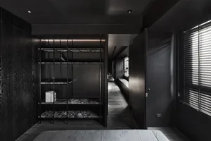 A modern bedroom featuring a black bookshelf made of metal, marble, and wood.