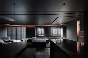 A modern living room with sleek, minimalist furniture and concrete surfaces.