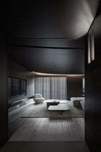 A modern living room with dark wood furniture and a minimalist design.