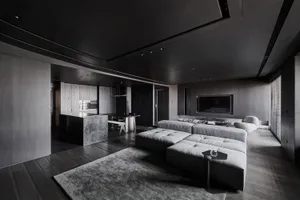 A modern living room featuring gray tones and contemporary design elements.
