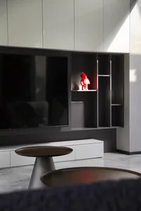 A modern living room featuring metal and glass elements.