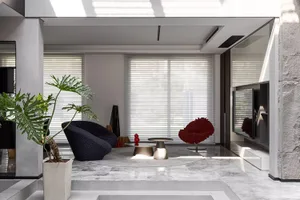 Modern minimalist living room with marble floors, minimalist furniture, and large windows
