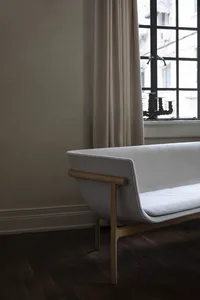 Contemporary sofa with white upholstery and wooden frame