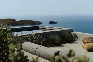A minimalist landscape featuring concrete and glass elements.