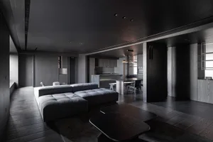 Minimalist design living room with dark wooden floor, grey sofa, and black coffee table.