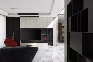 A modern living room with metallic accents and marble floor.
