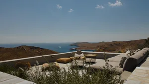 Minimalist design with concrete flooring, outdoor seating area, and ocean view.