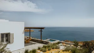 Minimalist exterior of a residential house featuring concrete and stone elements.