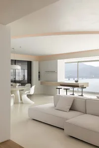 A modern contemporary kitchen with a concrete floor, white backsplash, and minimalist design features.