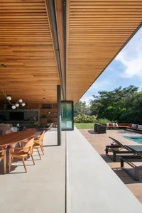 Modern outdoor living space with wooden planks, steel, and concrete