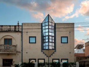 A modern building featuring a glass cube structure.