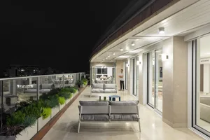 A modern terrace featuring concrete and glass materials.