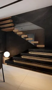 A modern, minimalist staircase with dark marble stairs and light wooden treads and risers, illuminated by warm lighting.