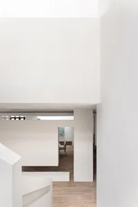 A minimalist white concrete residential interior with a modern and airy design.
