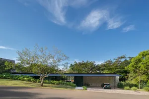 Modern house exterior featuring stone walls and a steel roof