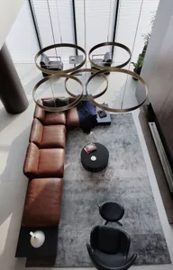 Modern living room with leather furniture and minimalist design elements.