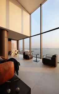 Modern living room with glass windows overlooking a scenic view.