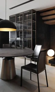 Modern dining room with marble table and leather chairs.