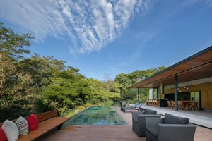Modern outdoor living area featuring wood and glass elements.