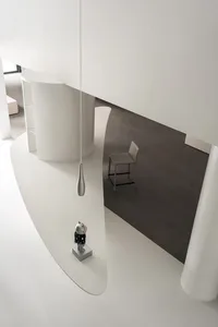 A minimalist modern interior design featuring clean white concrete surfaces and sleek stainless steel elements.