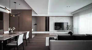 A modern living room featuring a marble wall, wooden furniture, and a large sofa.